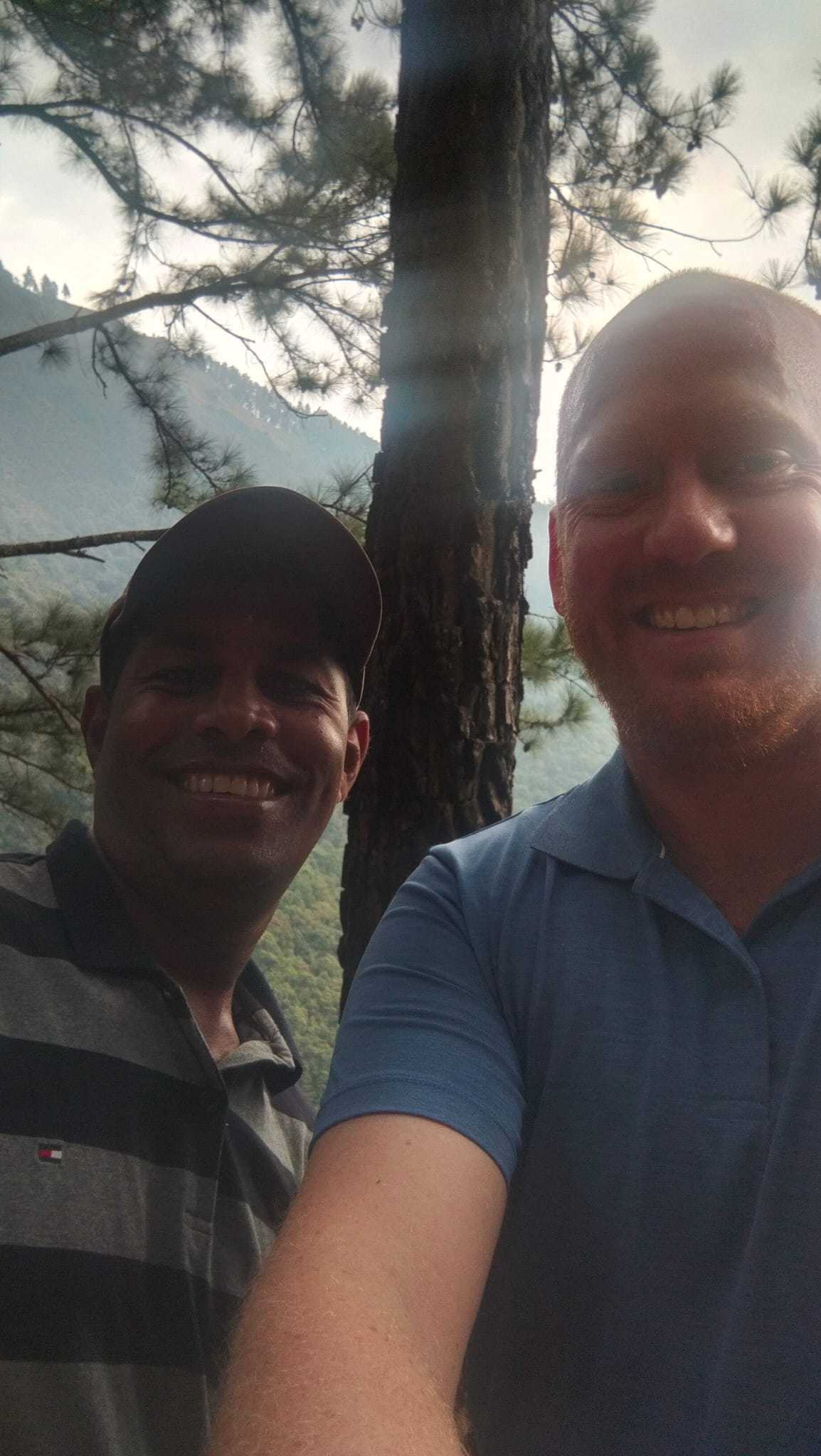 Selfie of a traveller and trekking guide in a forest in Sri Lanka