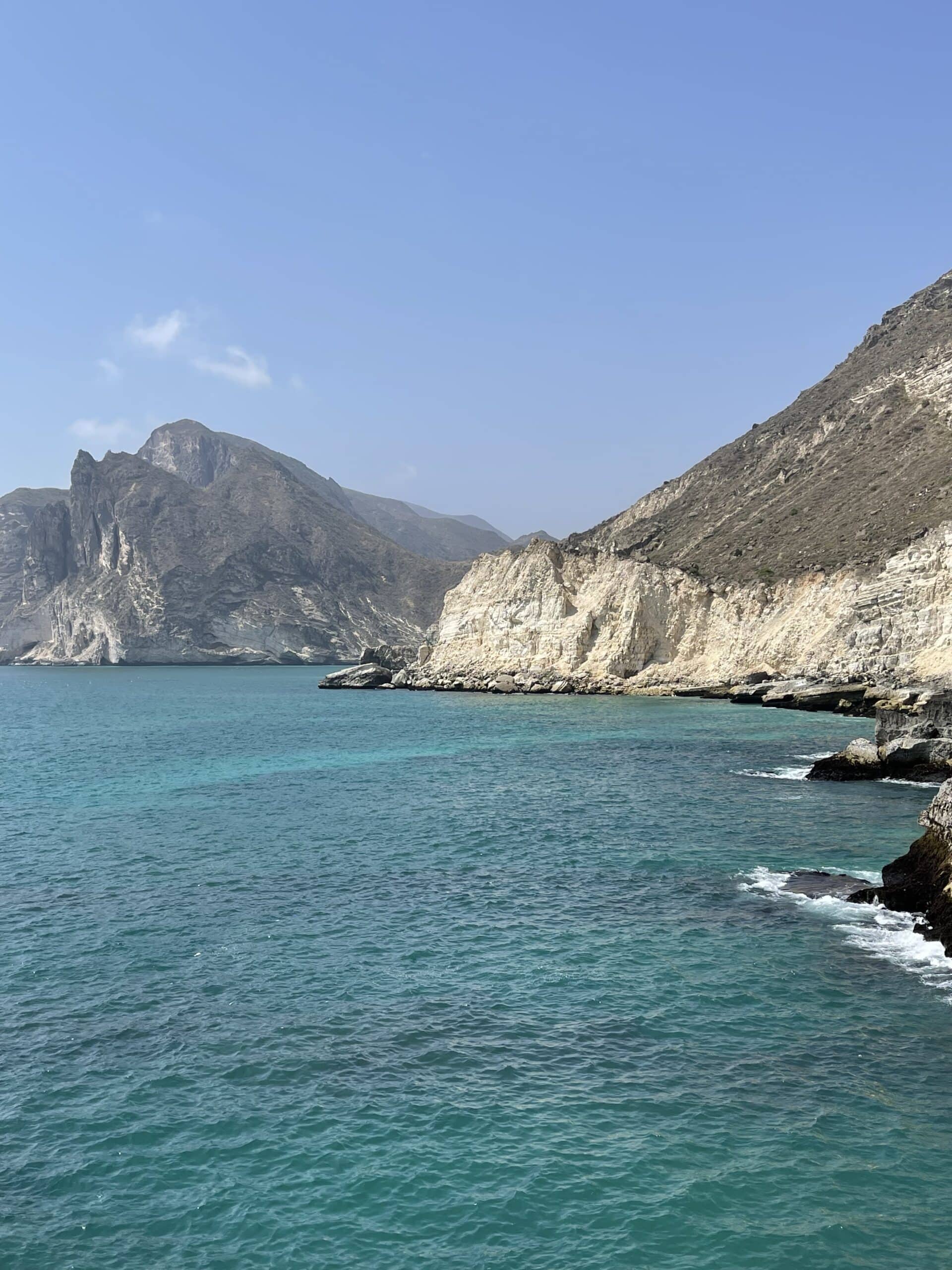 Turquoise waters and dramatic cliffs of Omans coastline