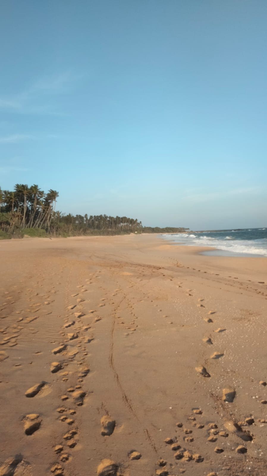 Deserted Rekawa beach with footsteps in the sand