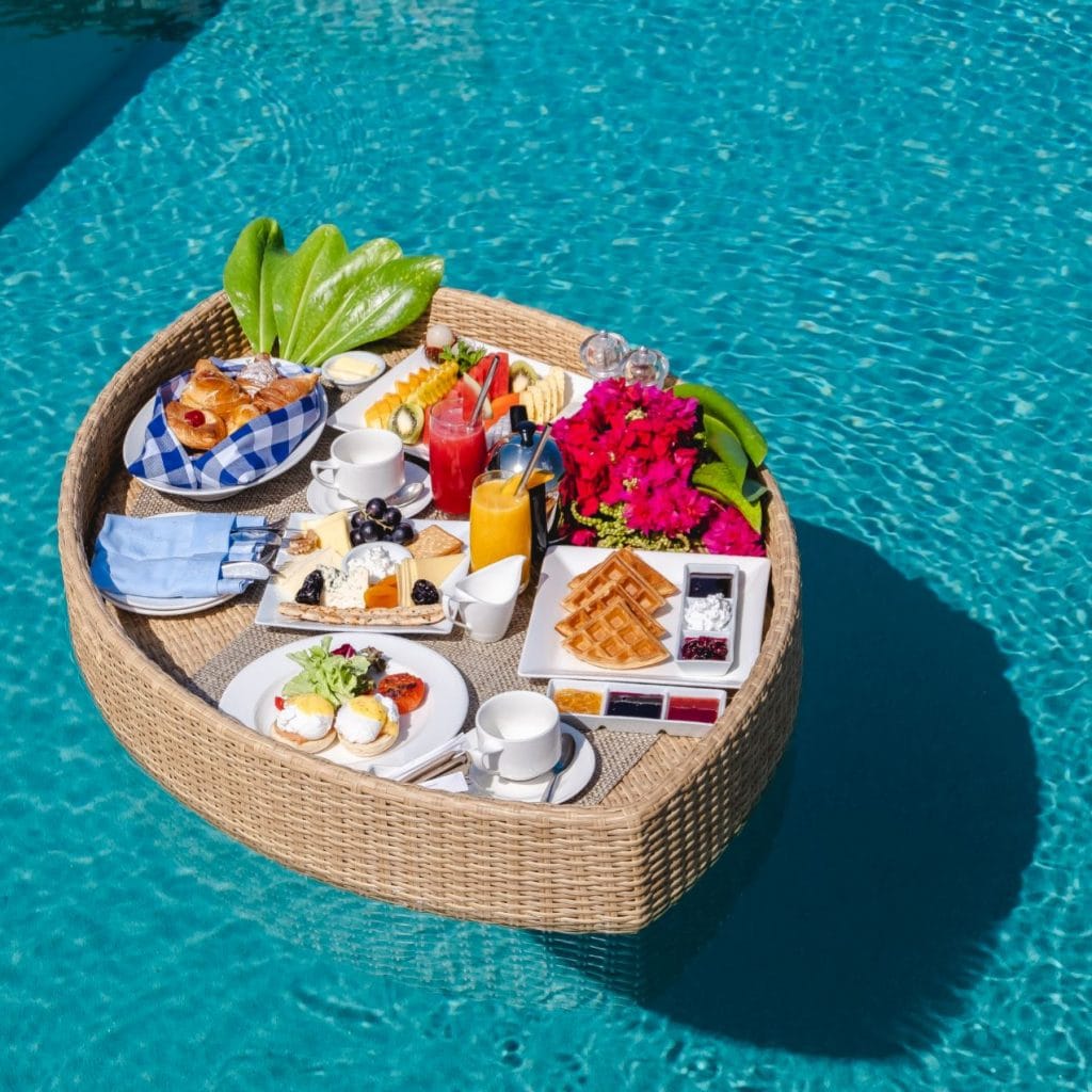 Picture of a floating breakfast in a small pool, taken from above