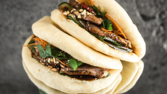 Bao bun filled with meat, vegetables and pine nuts.