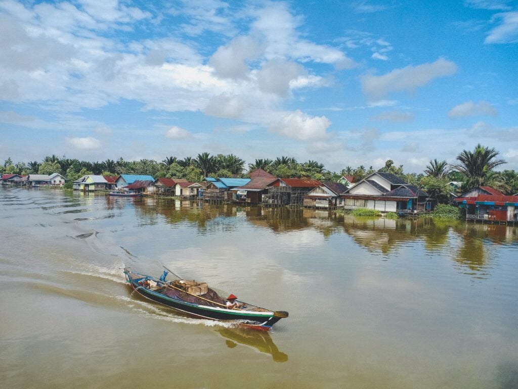 A boat travelling down a canal in Banjarmasin, Indonesia