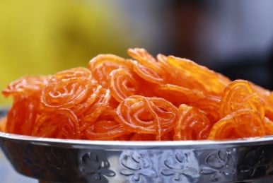 A metal bowl of Jalebi an Indian sweet dish