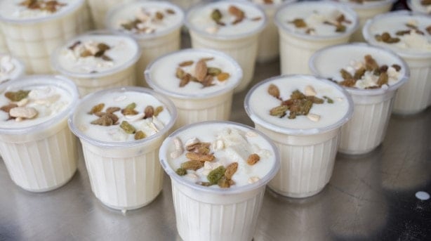Cups of Lassi, is an Indian yoghurt drink, decorated with nuts and dried fruit