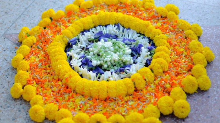 Bright and colourful pookalam (India flower arrangement)