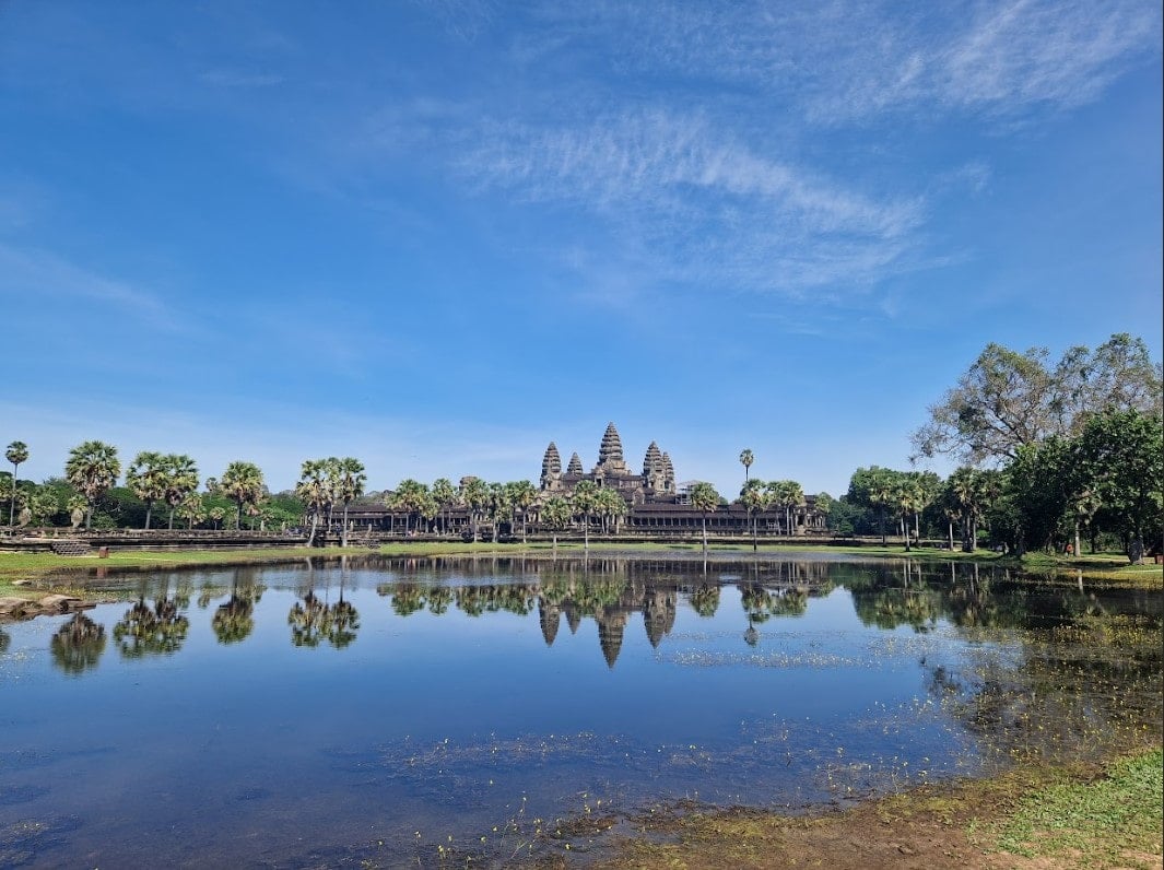 View of the Angkor Wat temple’s iconic 5 turrets from across the lake