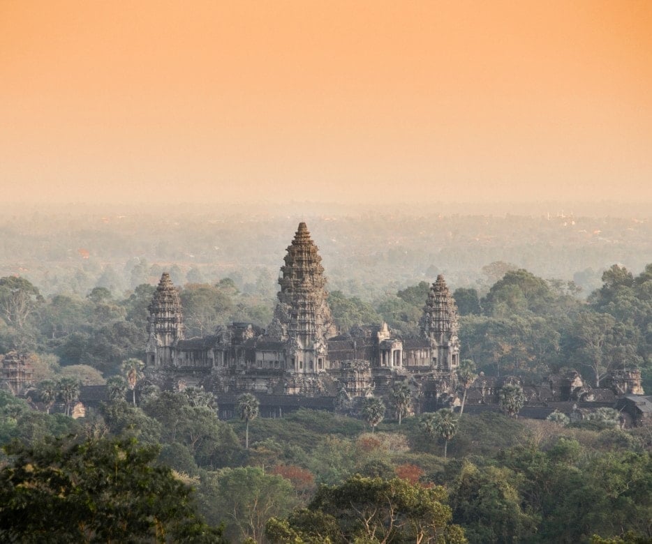 Angkor Wat temple with a hazy yellow sky.