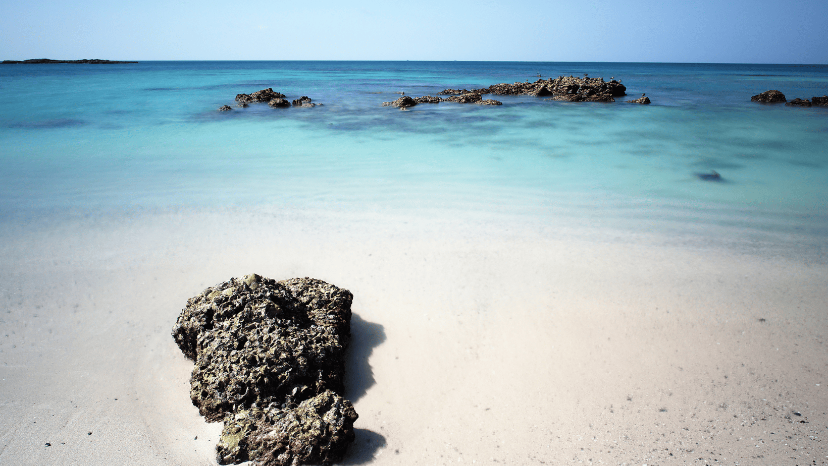 White Sand and turquoise water with rock formations on Masirah Island Oman