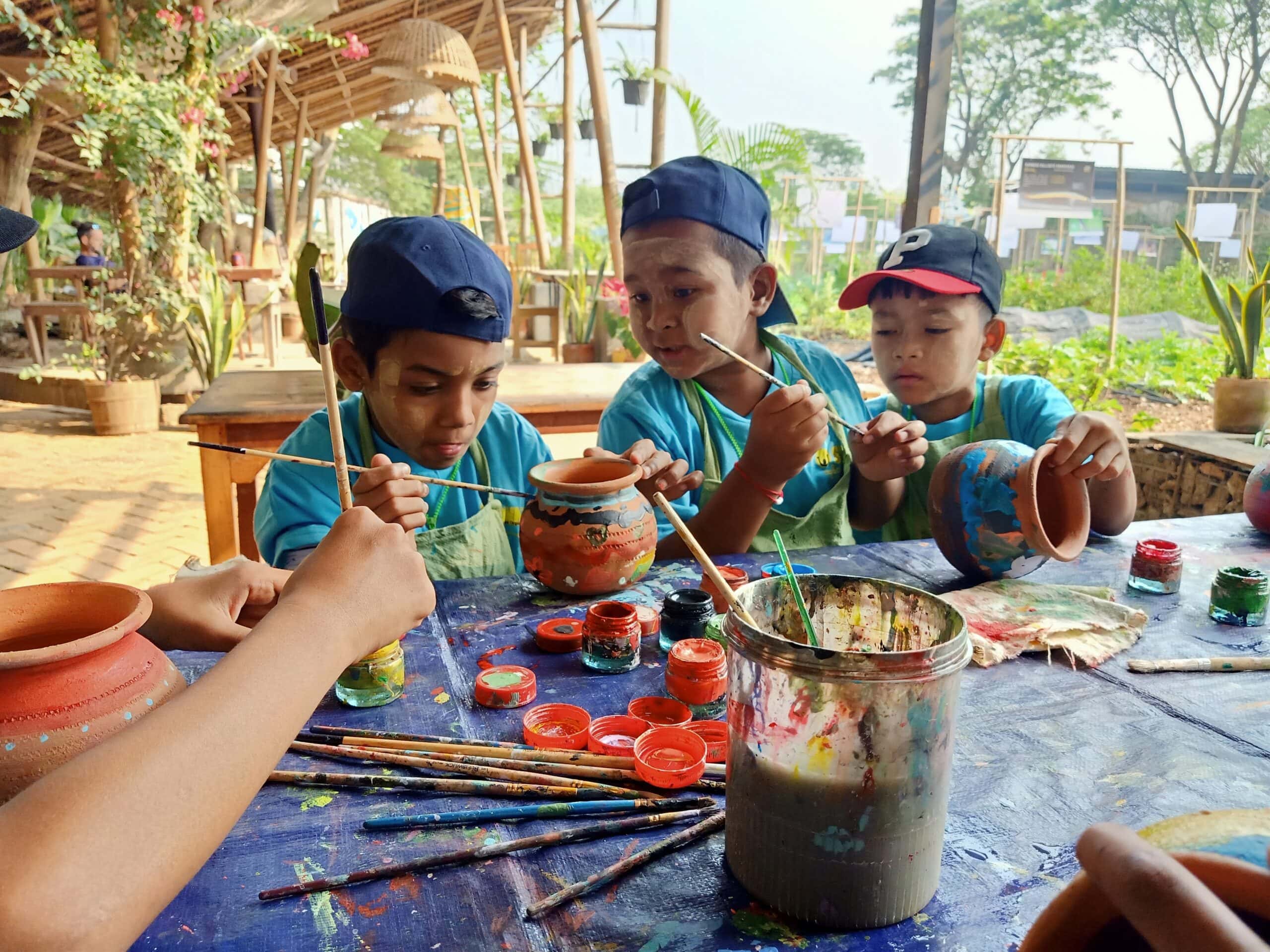 The children get creative painting plant pots to take home at Kokkoya Organic Farm, Yangon. March, 2023.