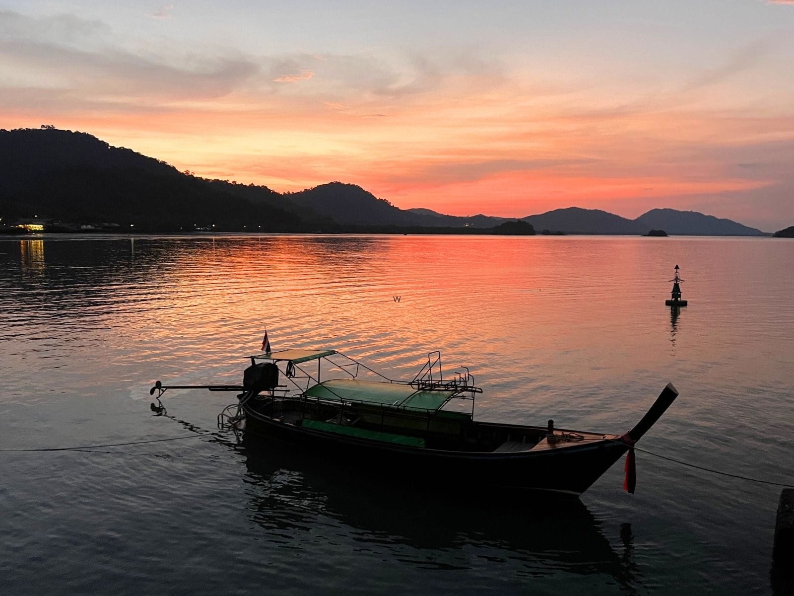 Sunset in Koh Lanta Island in Thailand with traditional boat