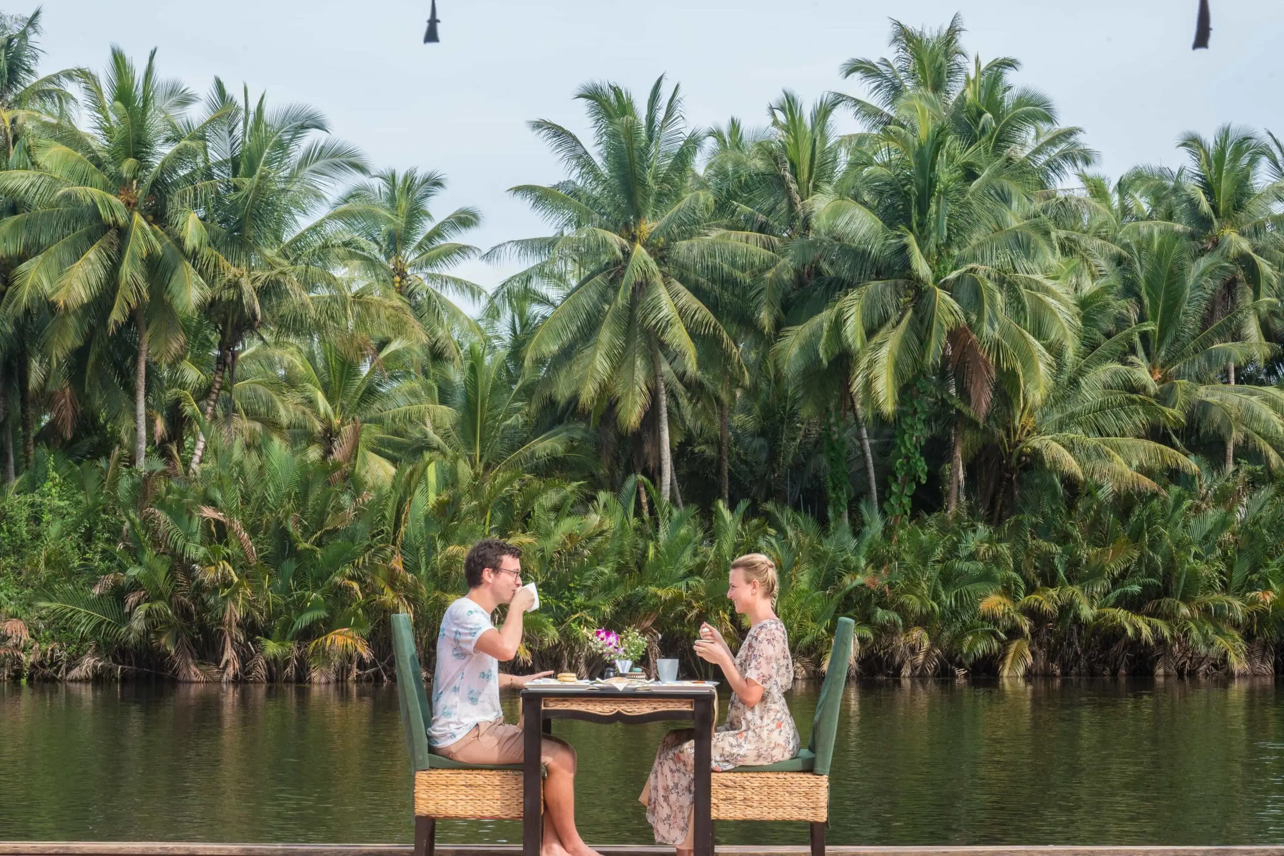 Canvas and orchids dining on the river