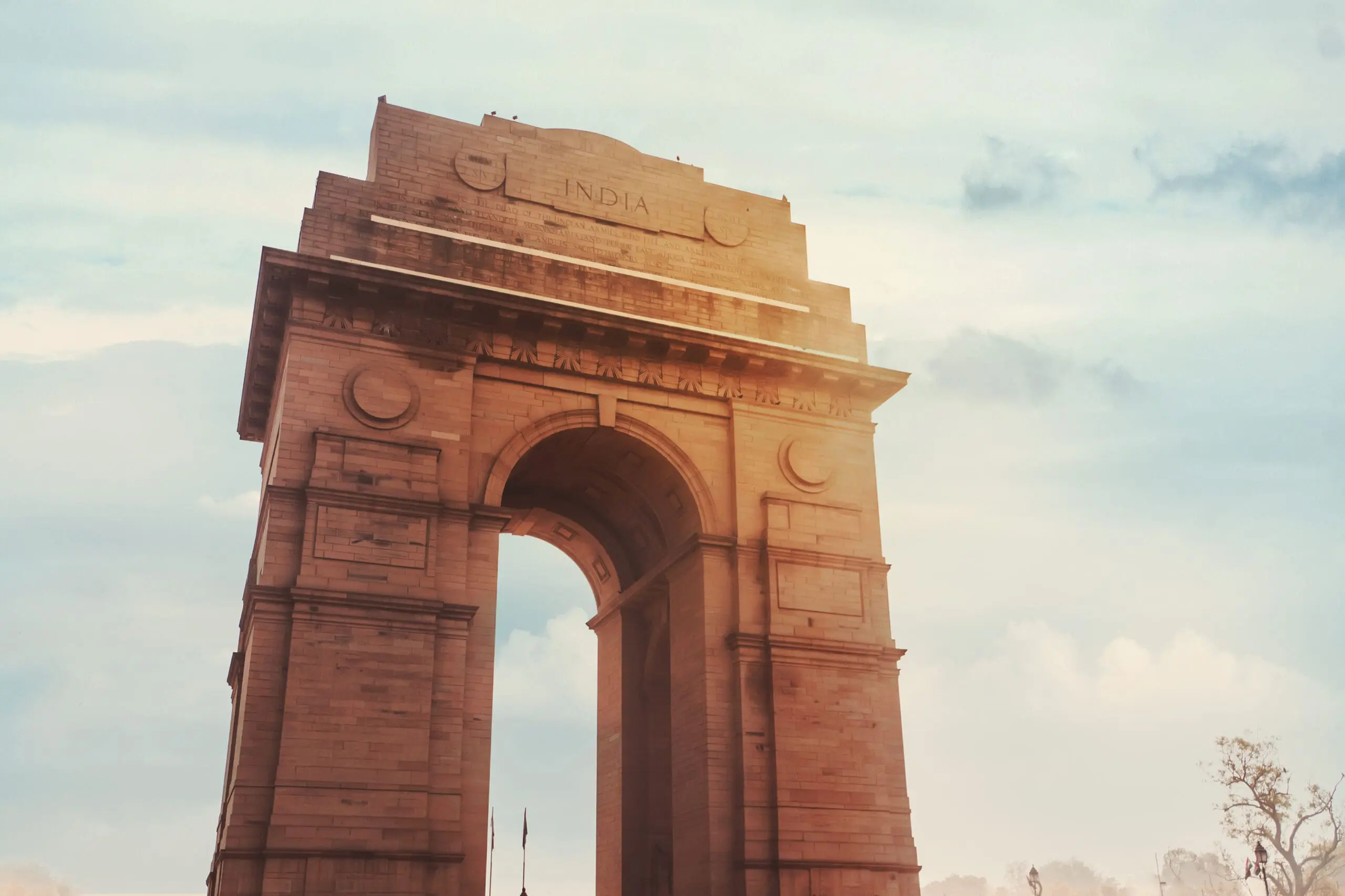 Historic India Gate Delhi - A war memorial on Rajpath road New Delhi. main Indian historical landmark in the background of the cloudy sky in the sunlight