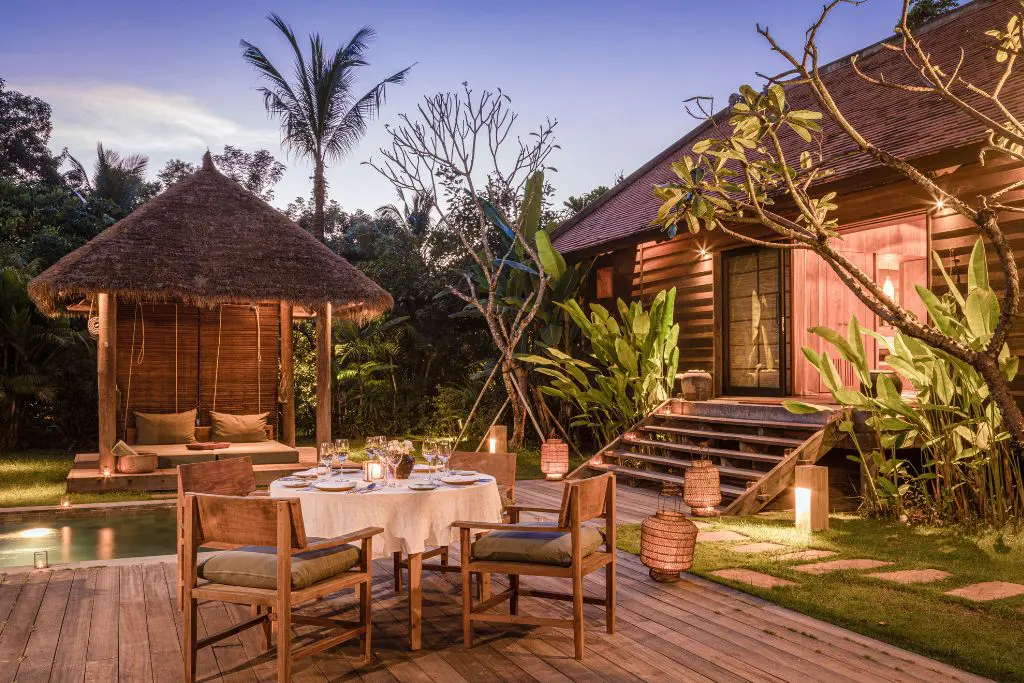 Private outdoor dining setup at Phum Baitang resort Cambodia at dusk