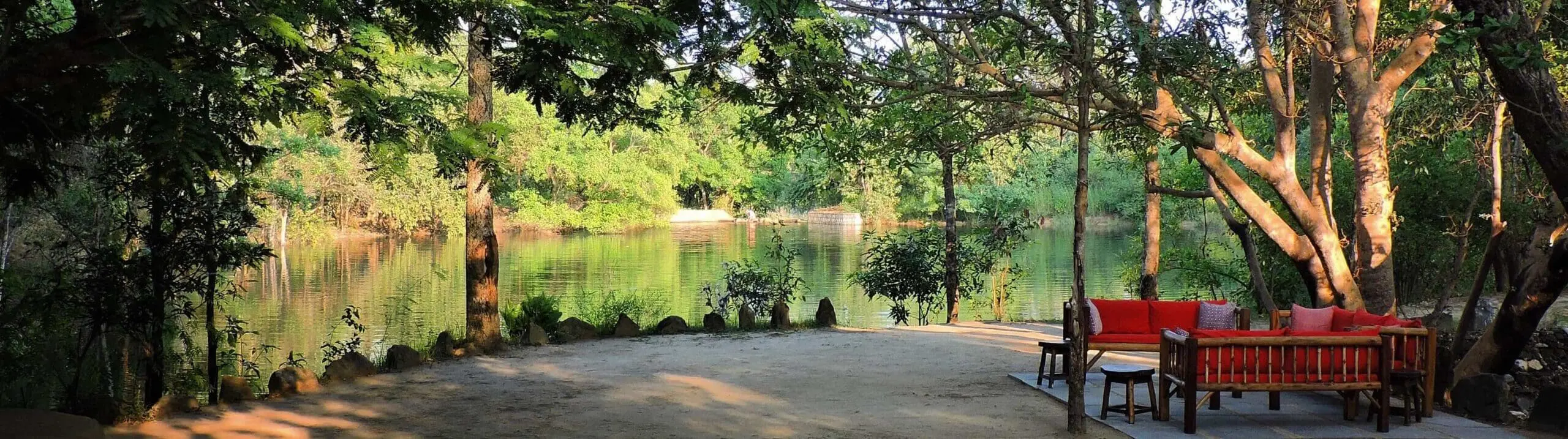 seating by lake at shergarh tented camp