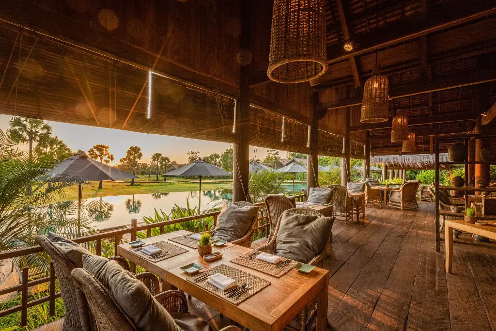 Open-air restaurant terrace at Phum Baitang resort Cambodia at sunset
