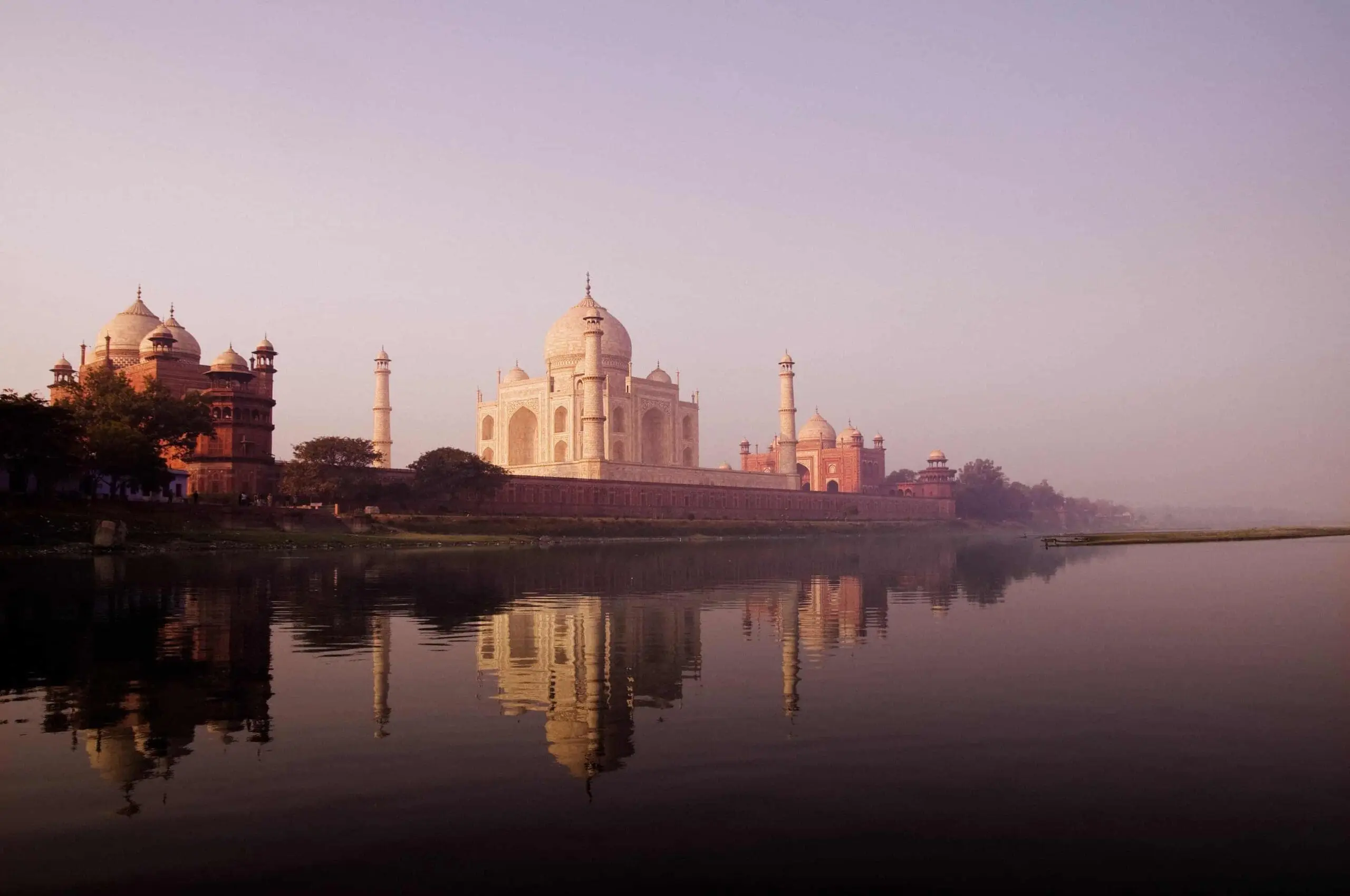 Taj Mahal at sunrise reflected in water in Agra India
