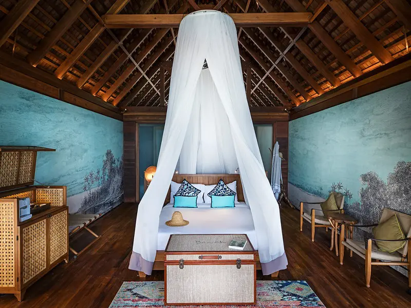 Luxury villa bedroom with canopy bed at Bawah Reserve Indonesia