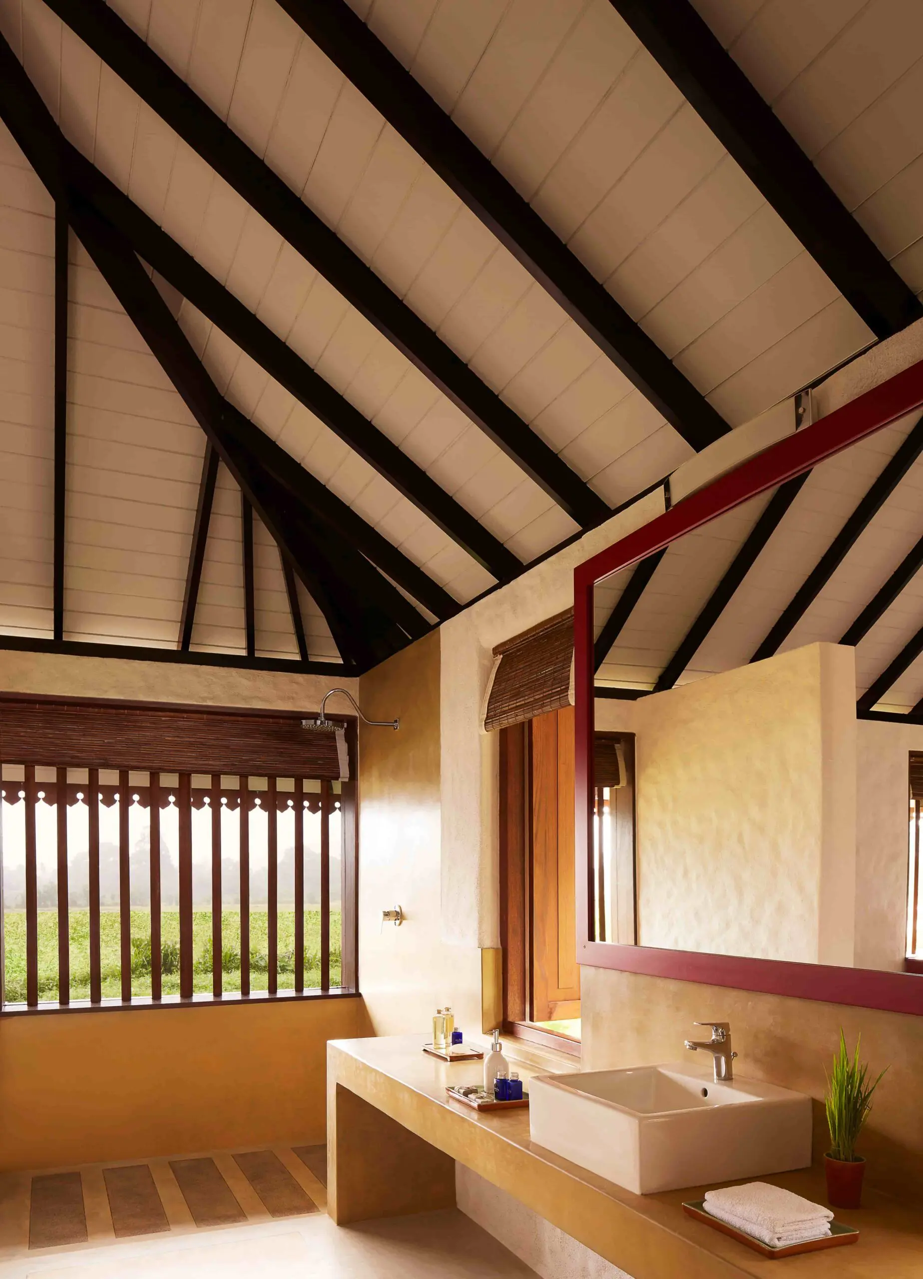 Spacious open-plan bathroom at Jetwing Kaduruketha with twin sinks and countryside views