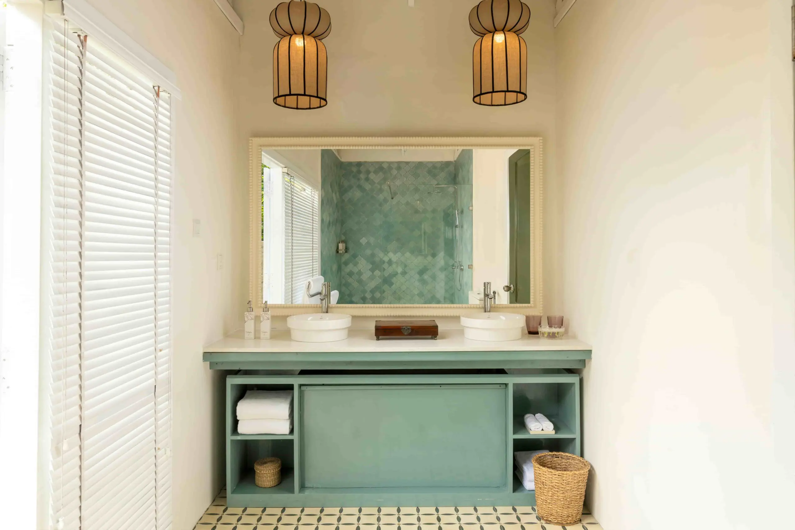 Bright bathroom at Uga Jungle Beach with twin sinks and walk-in shower