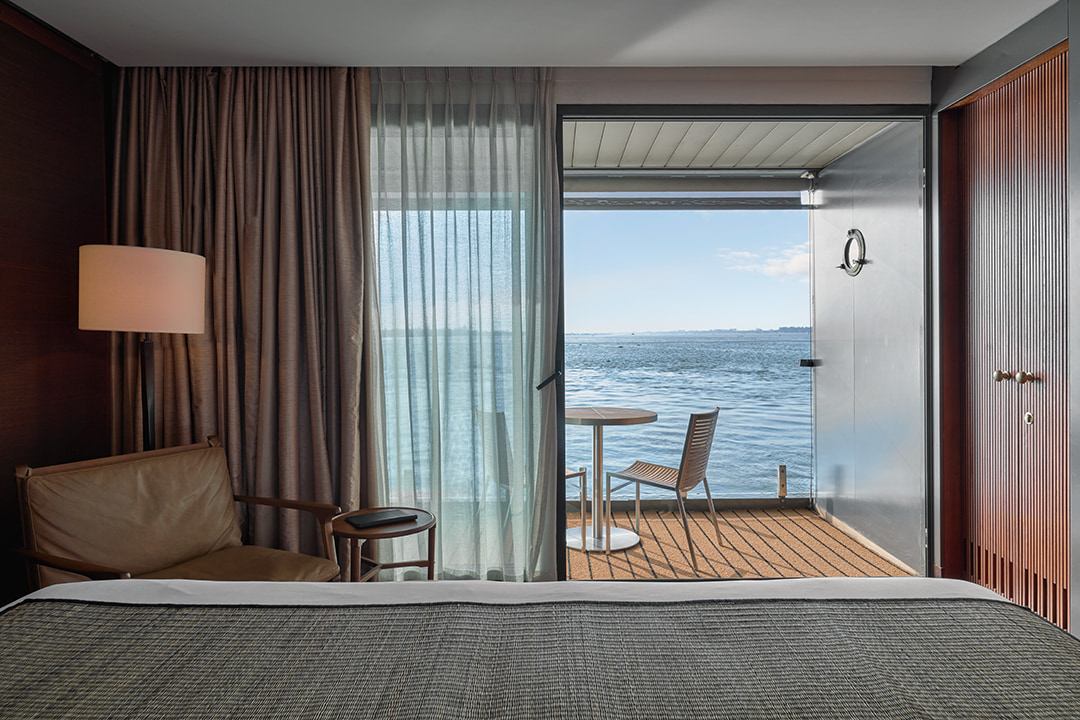 Aqua Mekong suite with private balcony overlooking the river