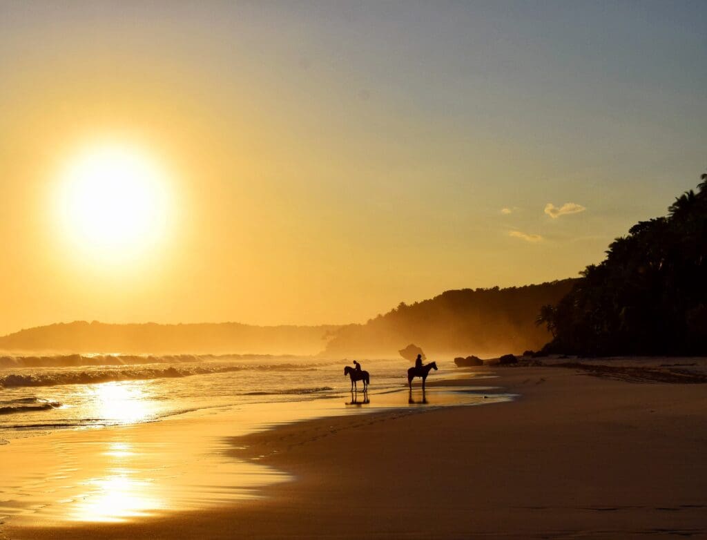 Riders on sumba island at sunset
