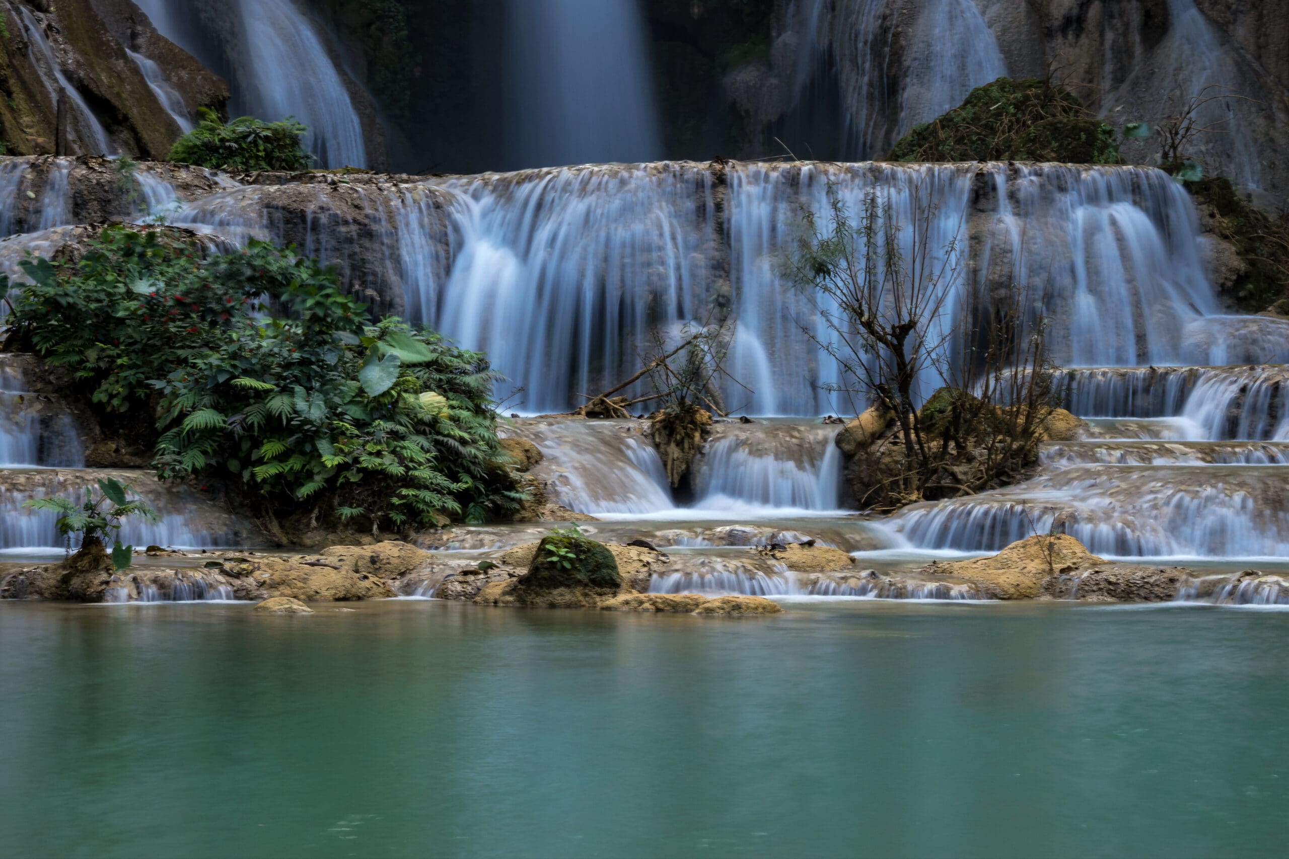 Tat Kuang Si Falls near Luang Prabang, Laos - Exotic travertine turquoise blue cascading waterfalls in Asia.