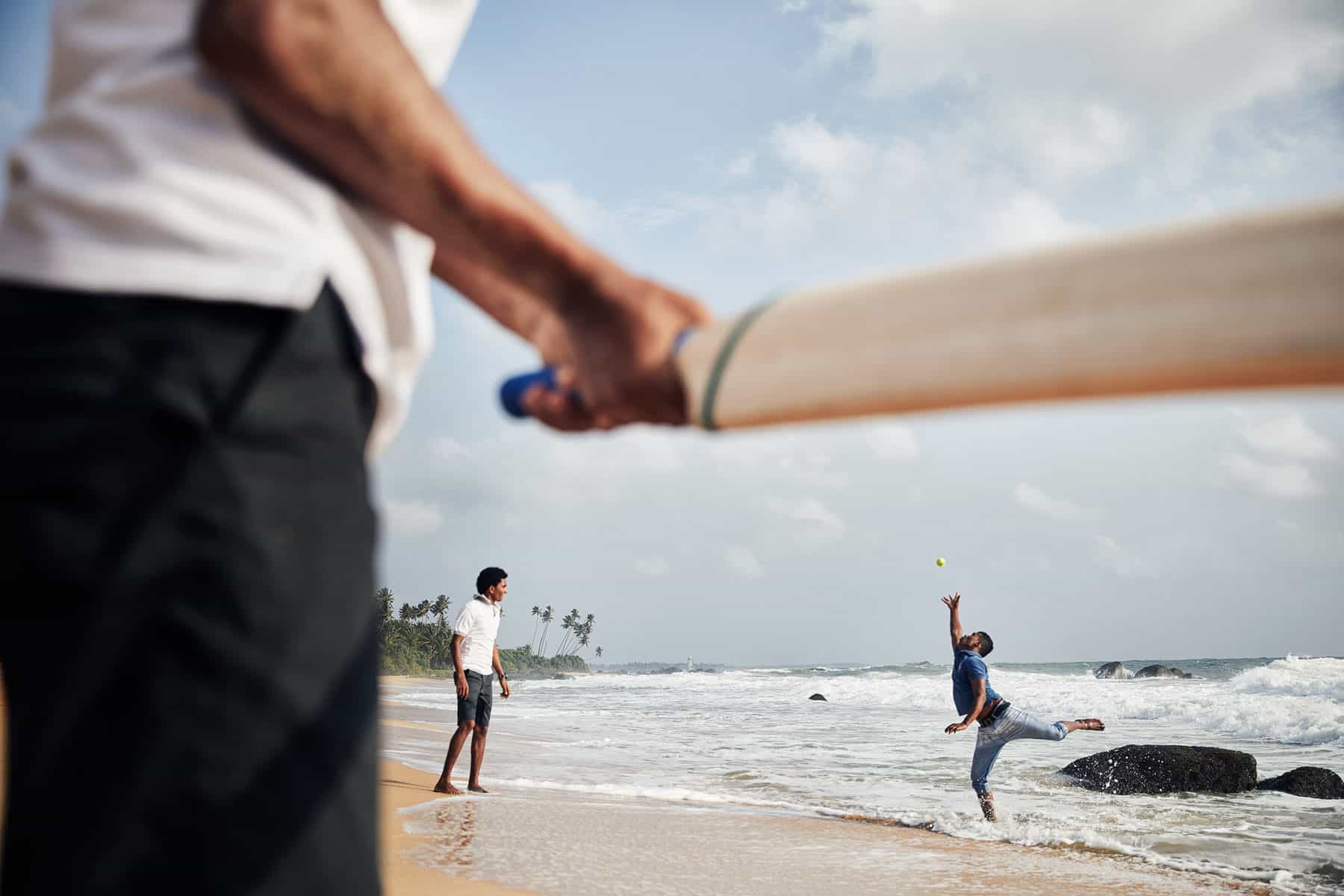 People playing cricket on Kumu Beach, Sri Lanka