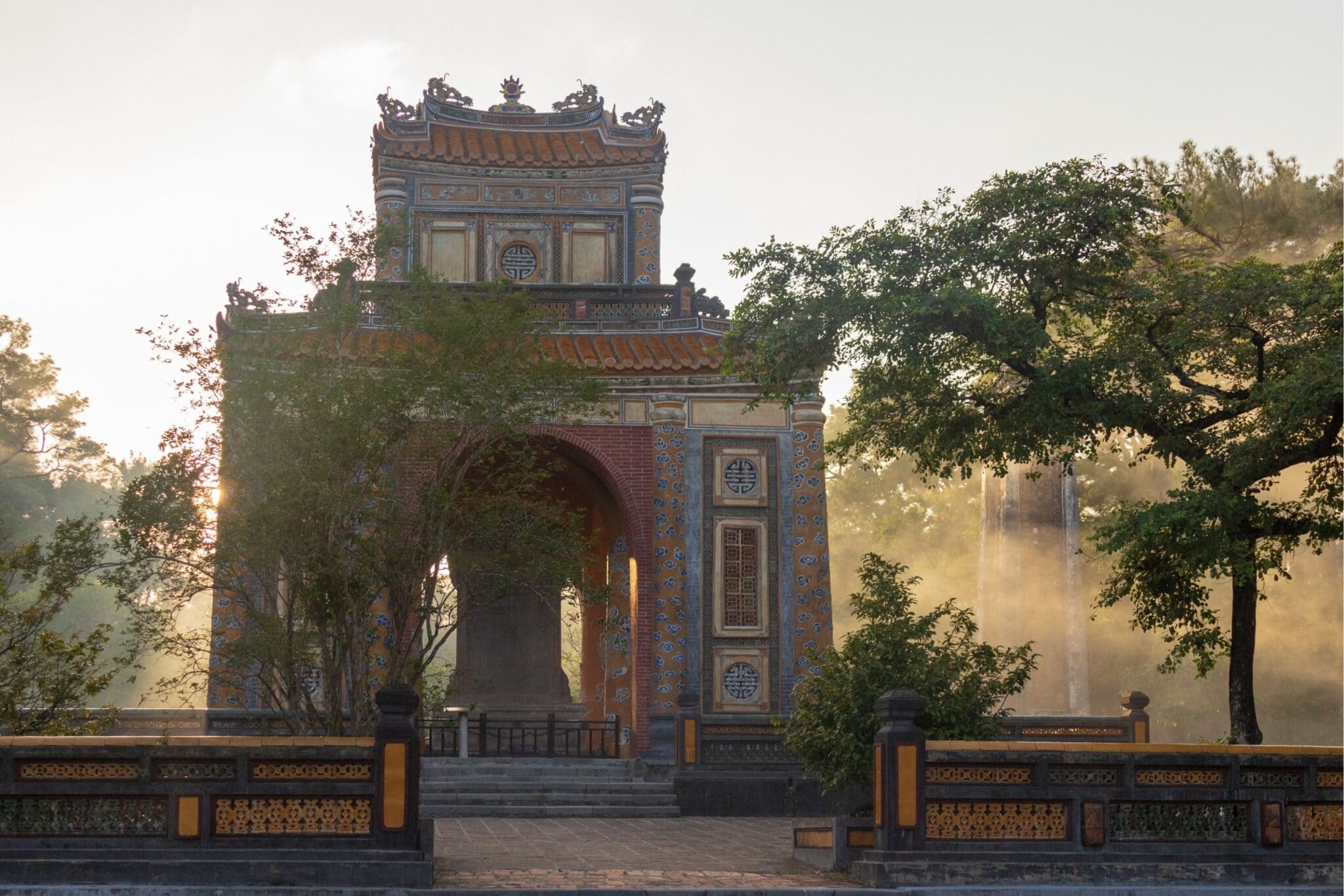 Historic gate in Hue Vietnam with traditional imperial architecture and trees
