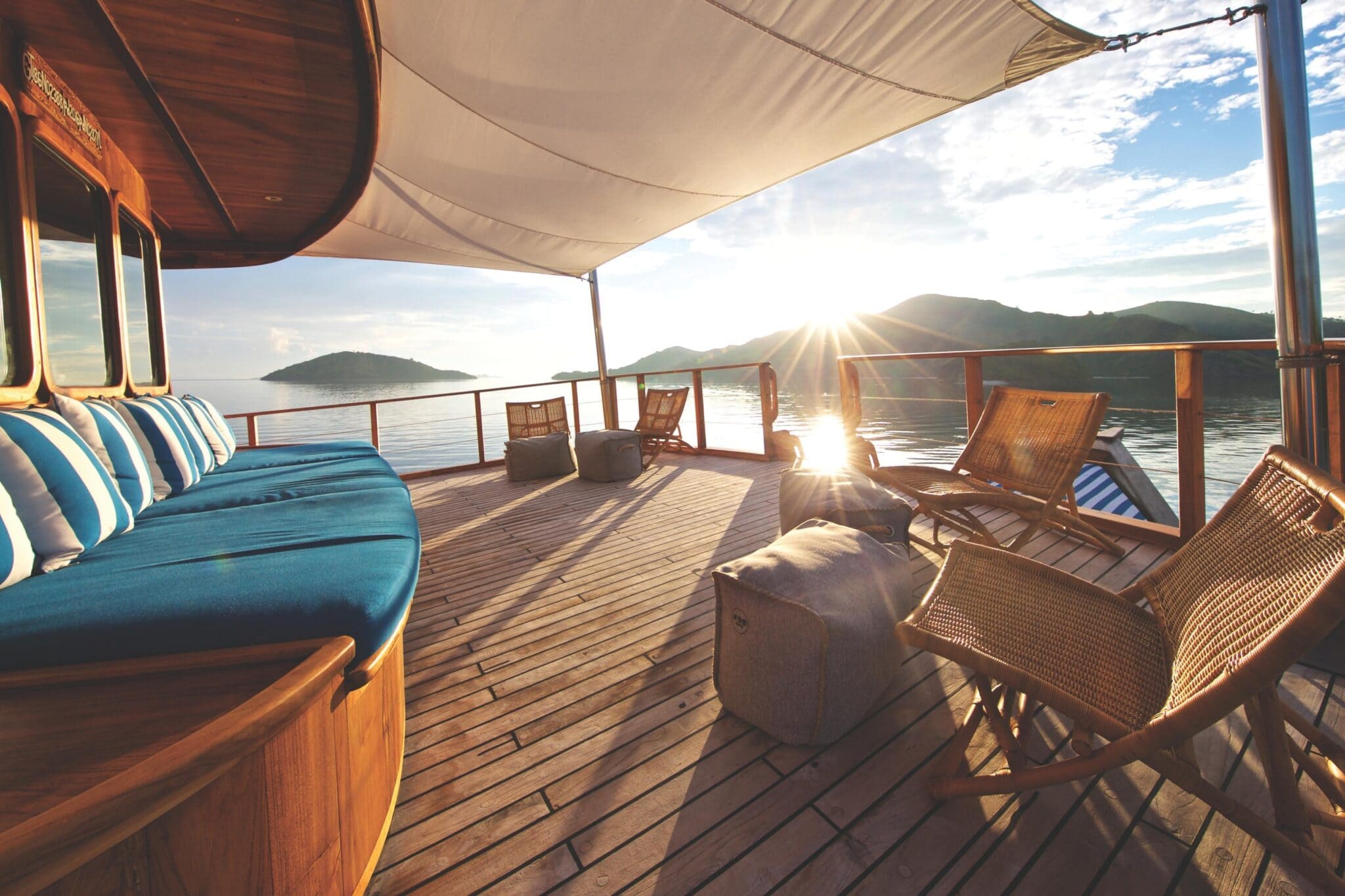 Luxury yacht deck at sunset in Indonesia with ocean views and relaxed seating