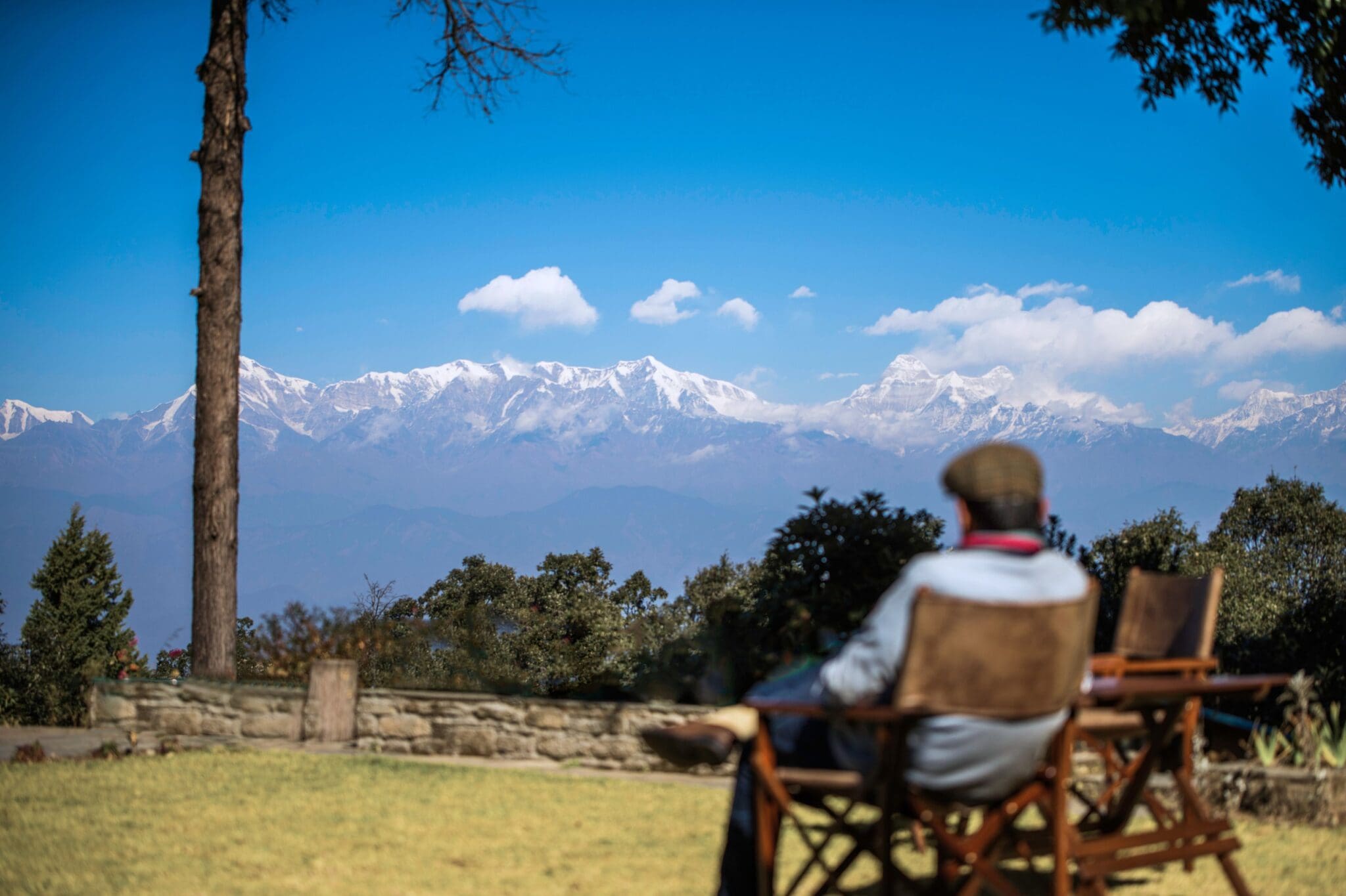 Traveller overlooking rural landscape in Uttarakhand India with Himalayan foothills