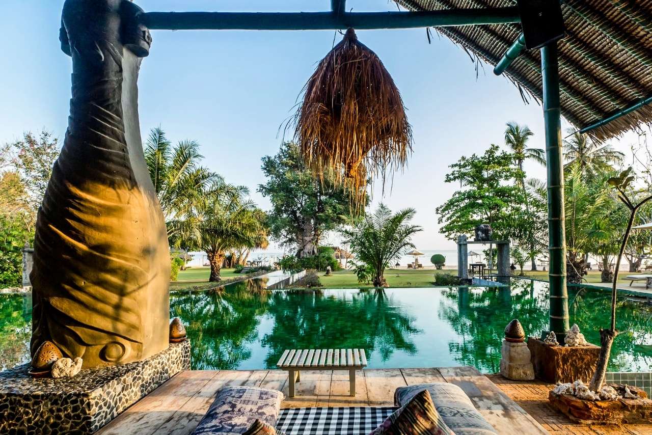 Swimming pool at Tugu Lombok with views towards the beach